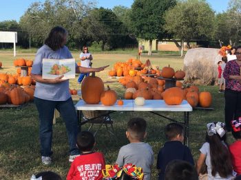 Woman reading kids a story at the annual Cornerstone Baptist Pumpkin Patch